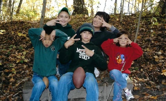 three brothers with little sister and exchange student from Korea in the forest