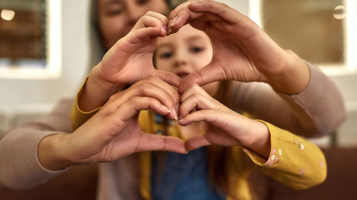 three people making hearts with their hands