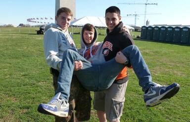 three teenage boys at a football field (1)
