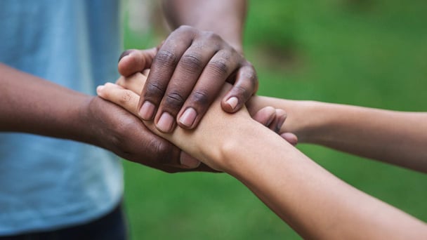 two sets of hands embracing to show empathy