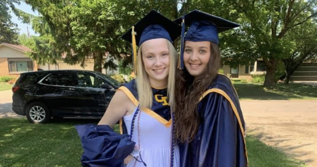 two teenage girls in graduation caps and gowns