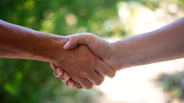 two young people shaking hands