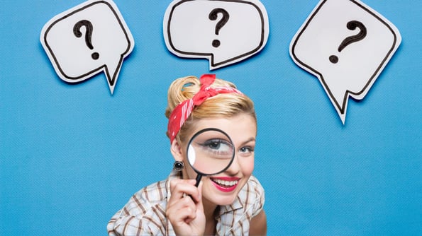 woman with magnifying glass with question signs