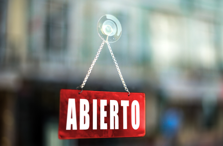 "Abierto" sign hanging on window