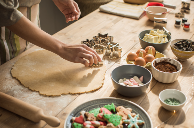 woman cutting out Christmas cookies