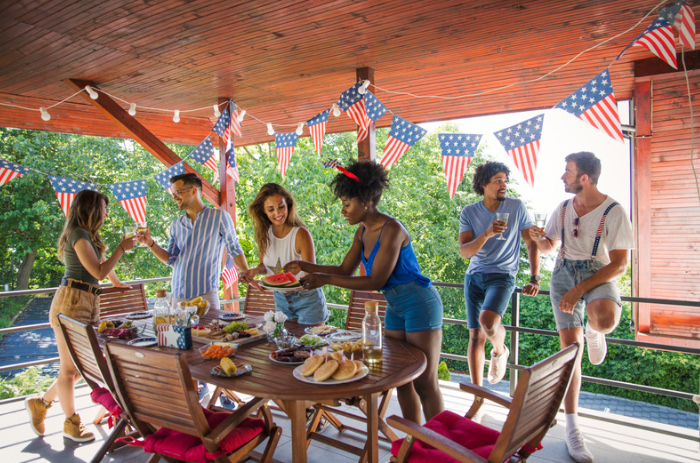 group of people having patriotic picnic on patio