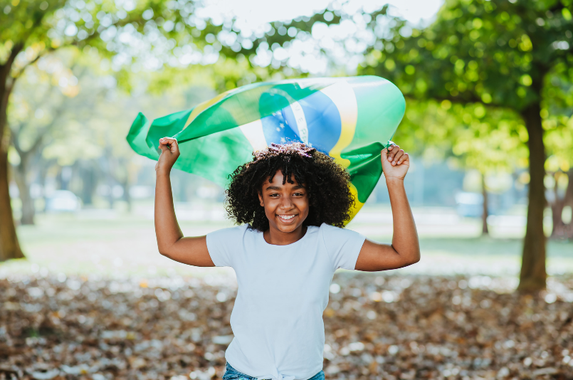girl with Brazilian flag over head