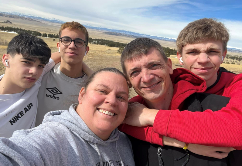 family selfie with plains in background